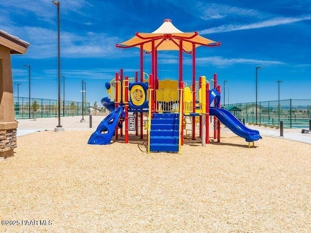 community jungle gym featuring fence