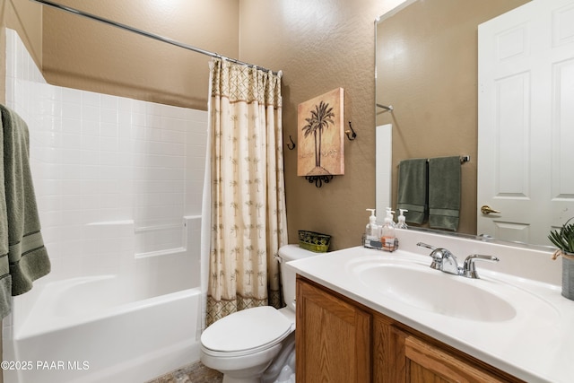 bathroom featuring shower / bath combination with curtain, toilet, a textured wall, and vanity