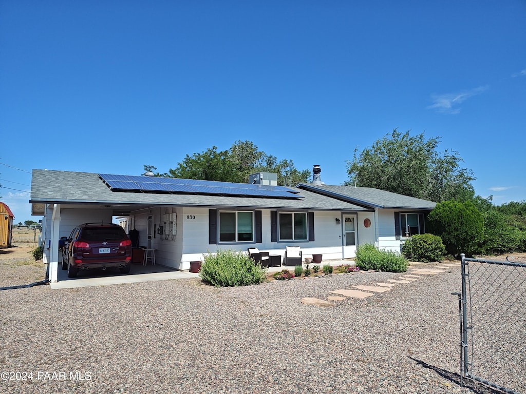 ranch-style house featuring a carport