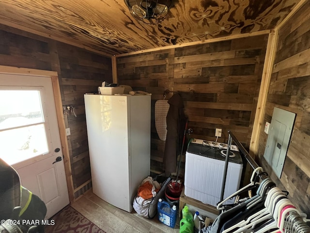 misc room with wood walls and washer / dryer