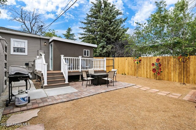 exterior space with a deck and fence