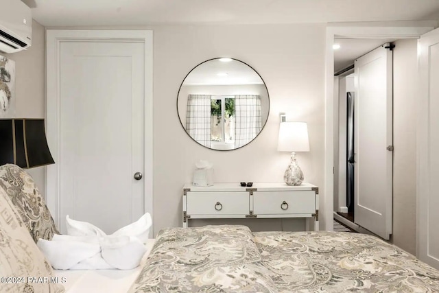 bedroom featuring a wall unit AC