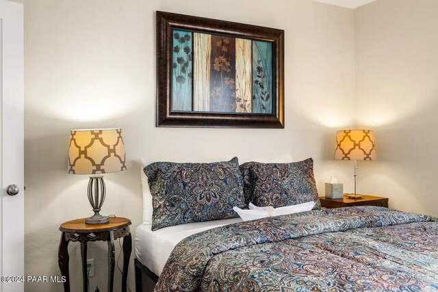 bedroom with ceiling fan, visible vents, baseboards, and wood finished floors