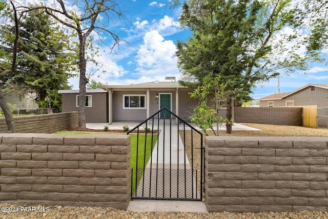 view of front of house featuring a gate and a fenced front yard