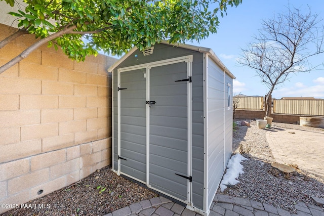 view of shed with a fenced backyard