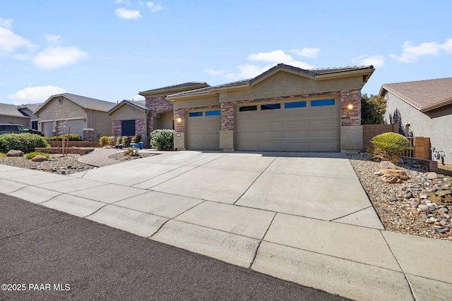 view of front of property with a tile roof, stucco siding, concrete driveway, and a garage