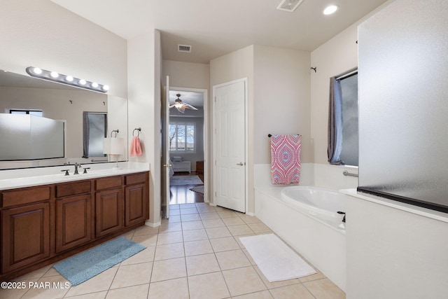 bathroom with vanity, tile patterned floors, a garden tub, and visible vents