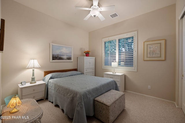 bedroom featuring visible vents, baseboards, light colored carpet, and a ceiling fan