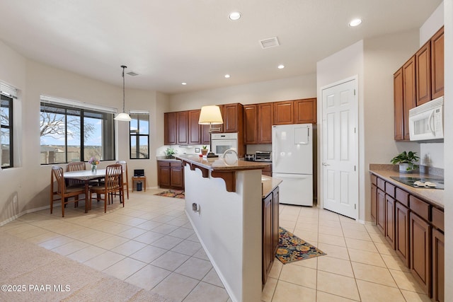 kitchen with visible vents, pendant lighting, recessed lighting, light tile patterned flooring, and white appliances