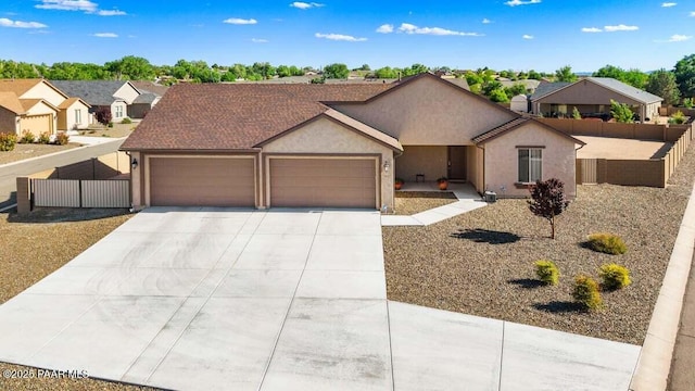 1657 Bainbridge Ln, Chino Valley, AZ 86323 - view of front facade featuring an attached garage, driveway, stucco siding, and a residential view