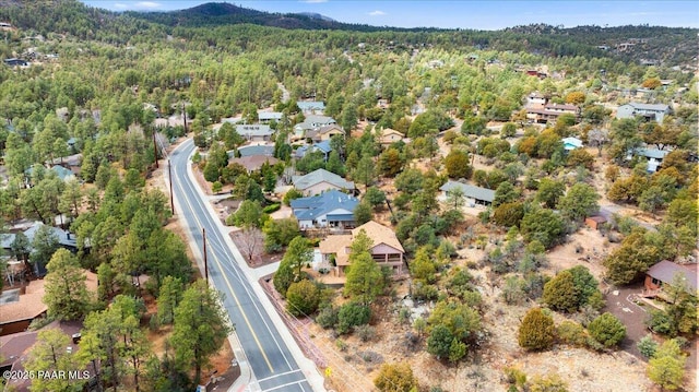 birds eye view of property with a view of trees