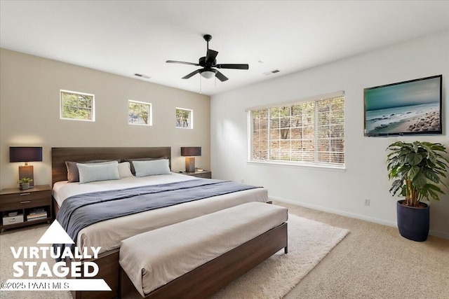 carpeted bedroom with multiple windows, visible vents, and baseboards