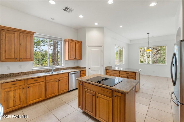 kitchen with a kitchen island, recessed lighting, brown cabinets, appliances with stainless steel finishes, and a sink