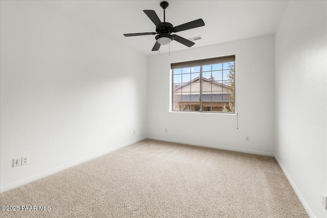 empty room with visible vents, baseboards, carpet, and a ceiling fan