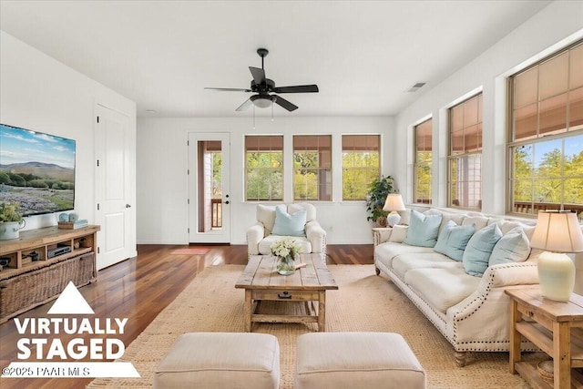 living room with visible vents, baseboards, ceiling fan, and wood finished floors