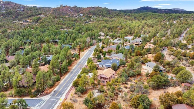 birds eye view of property featuring a forest view and a mountain view