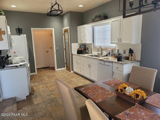 kitchen with dishwasher, white cabinets, an inviting chandelier, and sink