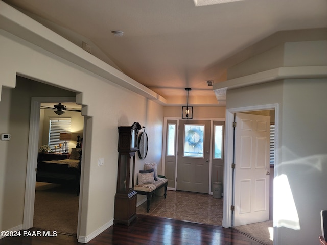 entryway featuring ceiling fan, dark wood-type flooring, and vaulted ceiling