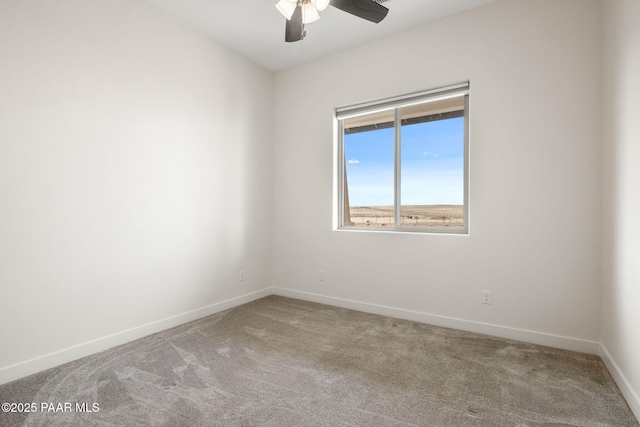 carpeted spare room with baseboards and ceiling fan