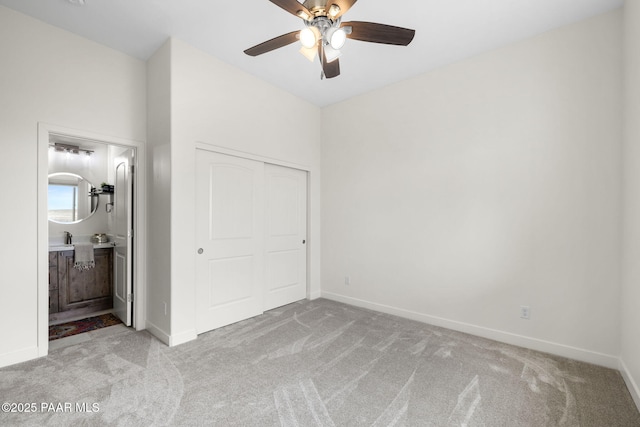 unfurnished bedroom featuring baseboards, a closet, and light colored carpet