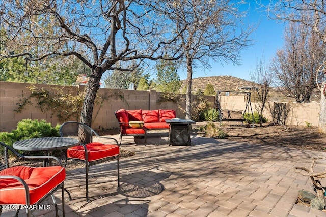 view of patio featuring an outdoor living space with a fire pit