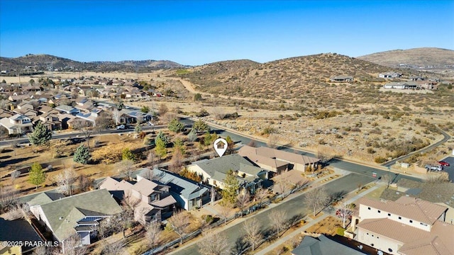 birds eye view of property featuring a mountain view