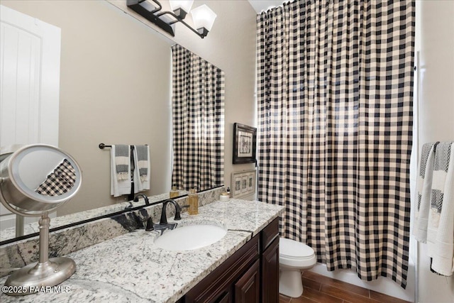 bathroom featuring toilet and vanity