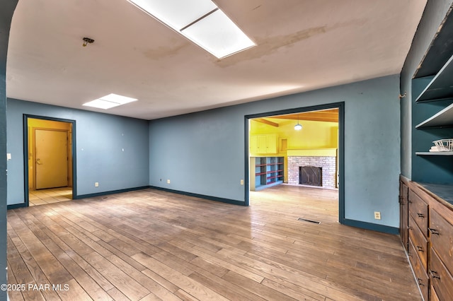 769 Cherokee Rd, Prescott, AZ 86303 - empty room with a fireplace and hardwood / wood-style flooring
