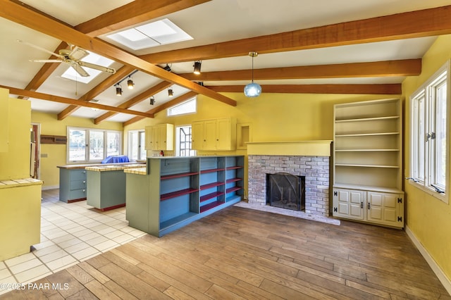 769 Cherokee Rd, Prescott, AZ 86303 - unfurnished living room featuring a skylight, hardwood / wood-style flooring, a ceiling fan, and plenty of natural light