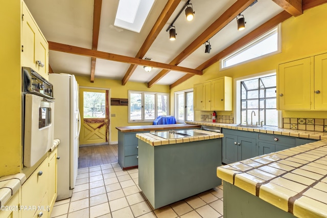 769 Cherokee Rd, Prescott, AZ 86303 - kitchen with white appliances, tile counters, plenty of natural light, and a skylight