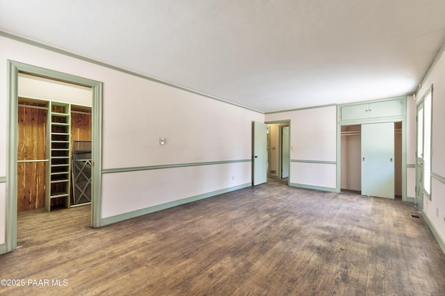 769 Cherokee Rd, Prescott, AZ 86303 - unfurnished bedroom with a closet, wood finished floors, and a spacious closet