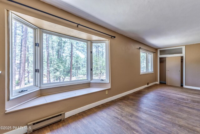 769 Cherokee Rd, Prescott, AZ 86303 - unfurnished bedroom with baseboard heating and wood finished floors