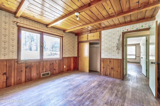 769 Cherokee Rd, Prescott, AZ 86303 - unfurnished bedroom with wallpapered walls, a wainscoted wall, a wooden ceiling with exposed beams, hardwood / wood-style floors, and a closet