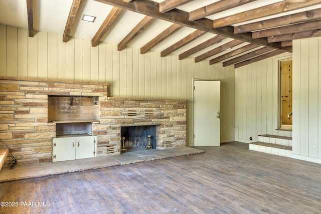 769 Cherokee Rd, Prescott, AZ 86303 - unfurnished living room featuring wood finished floors, beam ceiling, wood walls, and a stone fireplace