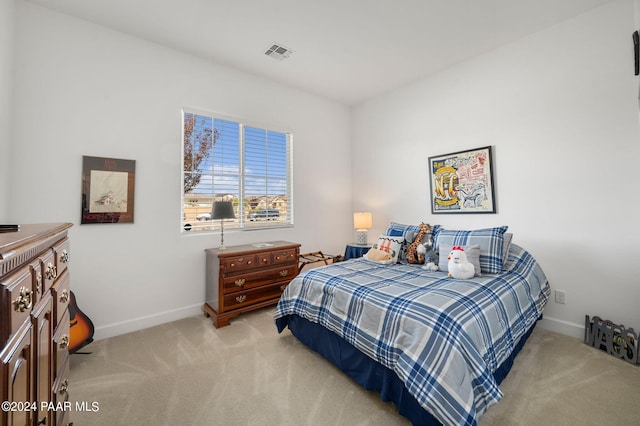 bedroom featuring light carpet