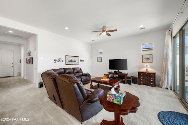 carpeted living room featuring ceiling fan