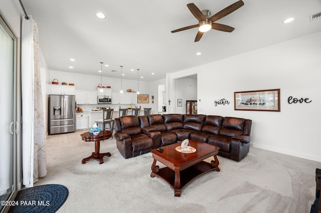 living room with ceiling fan and light carpet