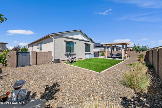 back of house featuring a patio area and a lawn