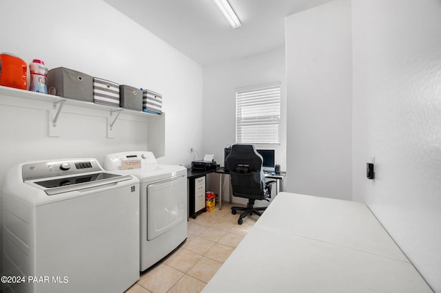 washroom with washer and clothes dryer and light tile patterned floors