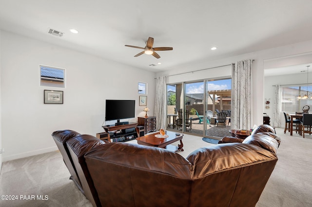 living room with light colored carpet and ceiling fan