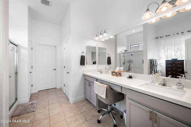 bathroom with tile patterned flooring, vanity, and an enclosed shower