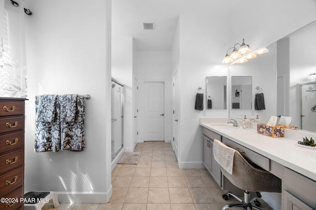 bathroom with vanity, tile patterned floors, and a shower with shower door