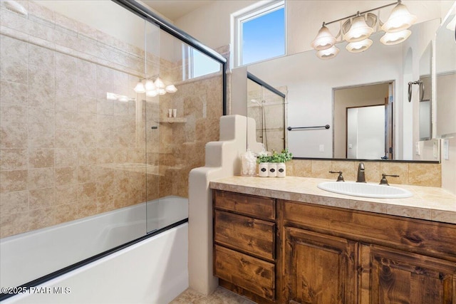 bathroom featuring vanity, enclosed tub / shower combo, and an inviting chandelier