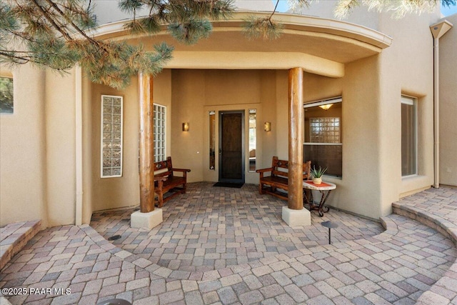 doorway to property with a patio area