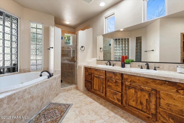 bathroom with tile patterned floors, vanity, and separate shower and tub