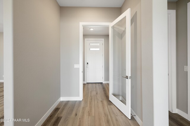 hall with light hardwood / wood-style flooring