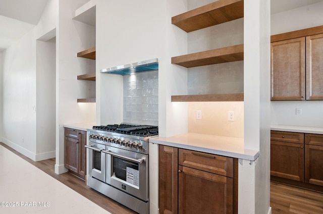 kitchen with double oven range, dark wood-type flooring, open shelves, and light countertops