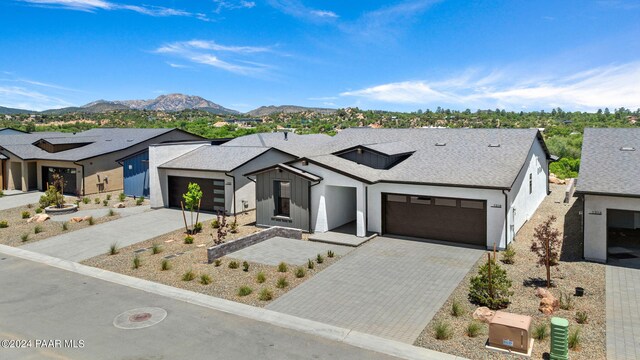 modern inspired farmhouse featuring a mountain view and a garage