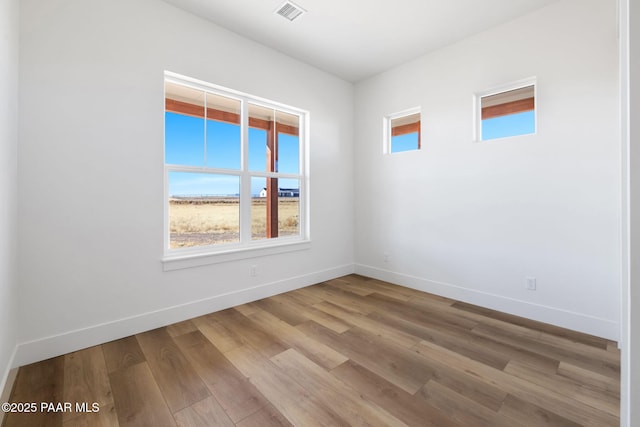 spare room with light wood-type flooring