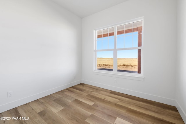 empty room with light hardwood / wood-style floors